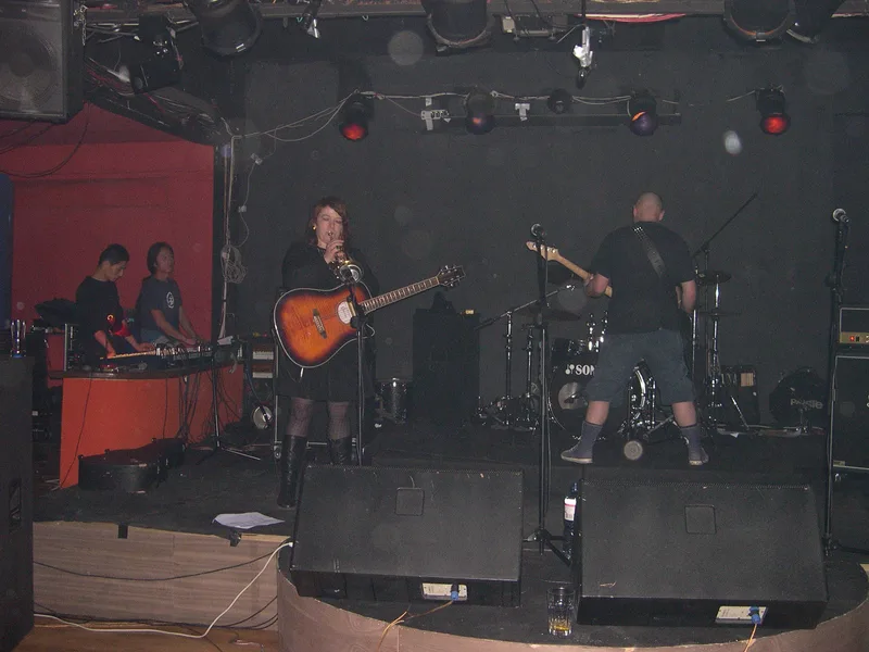 Katy on trumpet and Kjell on bass on the Yugongyishan stage, two guest musicians at keyboards to the left